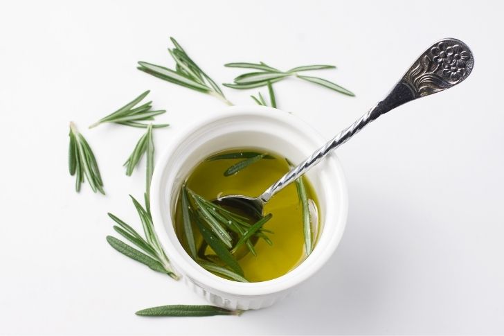 A bowl with rosemary oil for hair