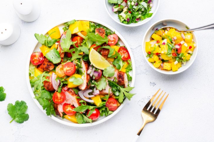 Chicken salad with avocado, cherry tomatoes.