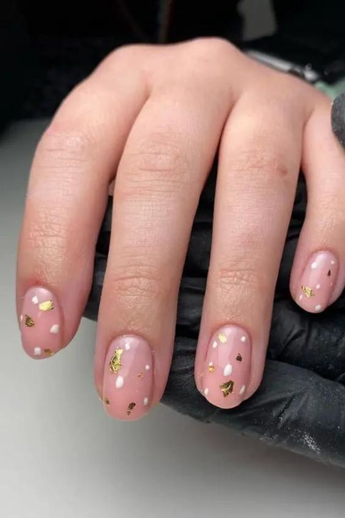 Short, Minimalist Nails Adorned with Gold Foil and White Dots